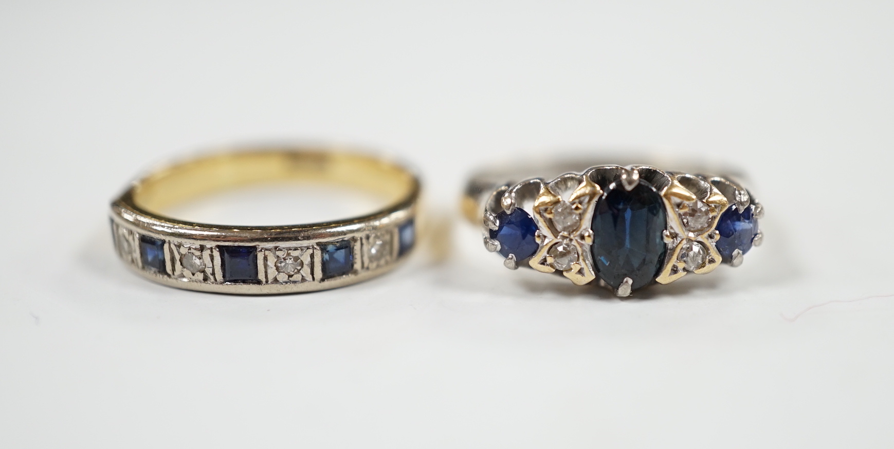 A George V 18ct white gold, sapphire and diamond cluster set ring, size K and one other 18ct, sapphire and diamond set half hoop ring, gross weight 7 grams.